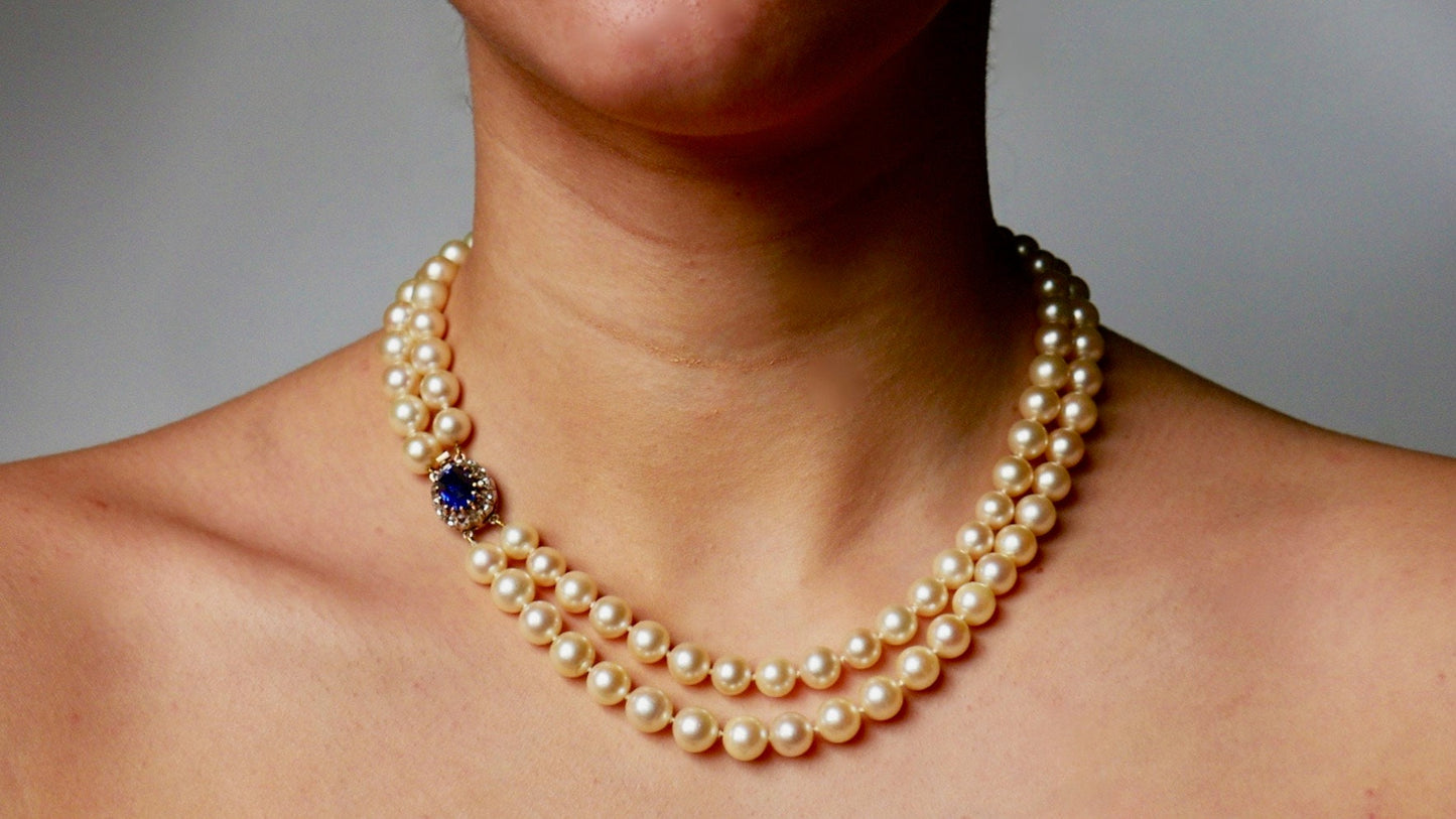 A Graduated Cultured Pearl Double String Necklace With Rose White Diamond & Ceylon Unheated Sapphire Clasp
