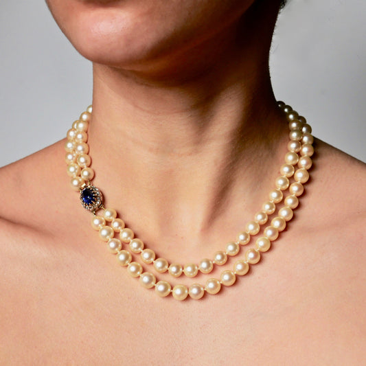 A Graduated Cultured Pearl Double String Necklace With Rose White Diamond & Ceylon Unheated Sapphire Clasp