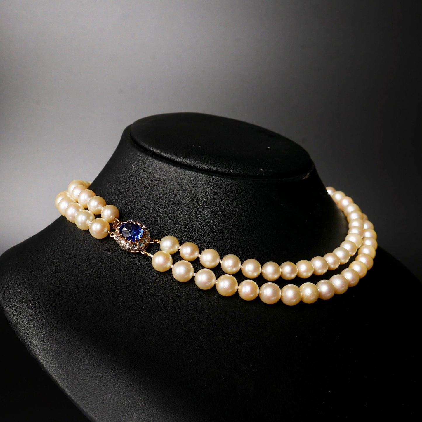 A Graduated Cultured Pearl Double String Necklace With Rose White Diamond & Ceylon Unheated Sapphire Clasp
